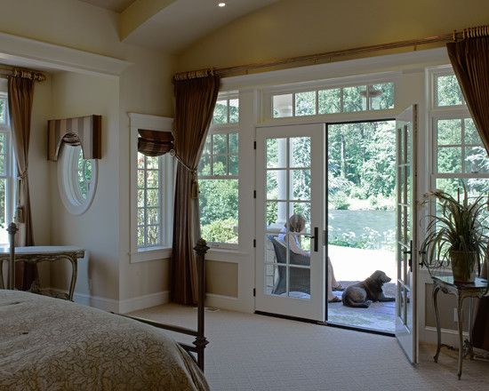 a large bedroom with french doors leading to the outside