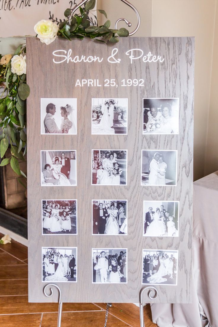 a wooden sign with photos on it sitting in front of a fire place and flowers