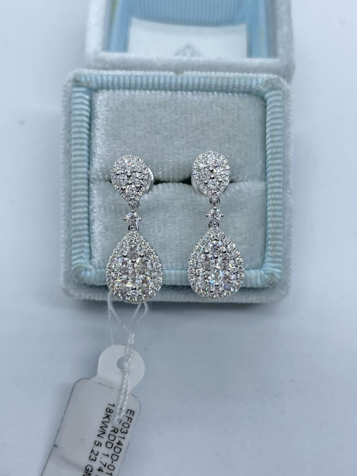 Gorgeous Pear Cut Diamond Dangling Earrings White Gold. Excellent craftsmanship, the diamonds are clean and very sparkling. This design is timeless and classy. The large push backs have double notches for a secure fit. Measures 24 x 9mm. Genuine Round Brilliant Cut Diamonds Total Weight: 1.74 Carats Clarity: VS/SI Color: G All white and shiny diamonds, no cloudy or yellowish stones Solid 18K White Gold Comes with gift box * We have been in the wholesale Jewelry business for over 30 years serving Pear Cut Diamond Earrings, Dangling Diamond Earrings, Pear Diamond Earrings, Diamond Dangling Earrings, Morganite Engagement Ring Oval, 10th Wedding Anniversary Gift, Flower Diamond Ring, Gold Diamond Hoop Earrings, Earrings White Gold