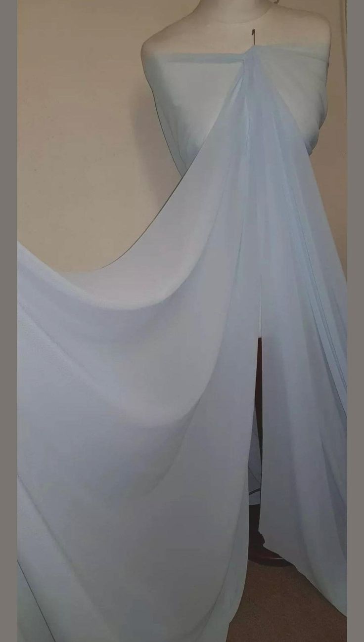 a white dress on display in front of a mannequin