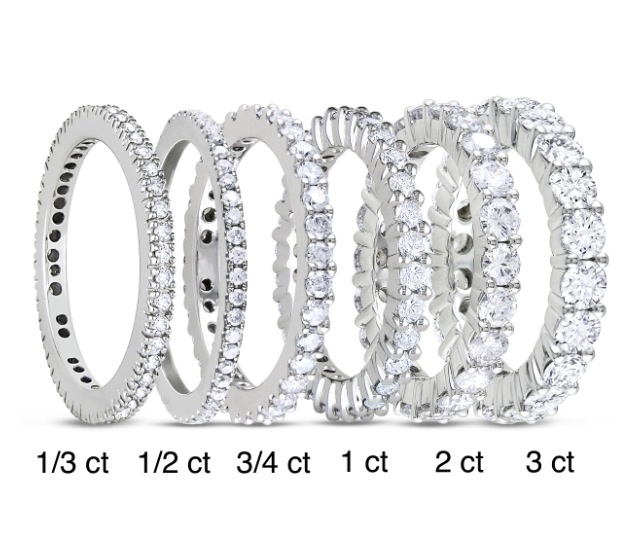 a set of five different sized wedding rings with white diamonds on each ring and the width is