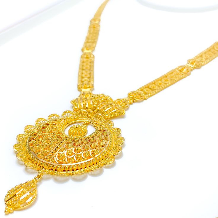 This 22k gold set, weighing a luxurious 60.7 grams, features an extravagant netted floral design that marries sophistication with intricate artistry. The yellow gold finish beautifully highlights the delicate floral motifs, giving the set a lavish and elegant allure. The set's 24-inch length is enhanced by an impressive 3.5-inch drop, and 0.6 inches of adjustable links provide a perfect, customizable fit. A reliable hook lock ensures the necklace stays secure, while the matching 1.5-inch earring Luxury 22k Gold Jewelry For Reception, Luxury 22k Gold Bollywood Necklace, Luxury Long Gold Sets, Luxury 22k Gold Hand Set Necklace, Hand Set 22k Gold Luxury Necklace, Luxury 22k Gold Traditional Jewelry, Yellow Gold Meenakari Jewelry Sets For Diwali, Meenakari Yellow Gold Jewelry Sets For Diwali, Diwali Meenakari Yellow Gold Jewelry Sets