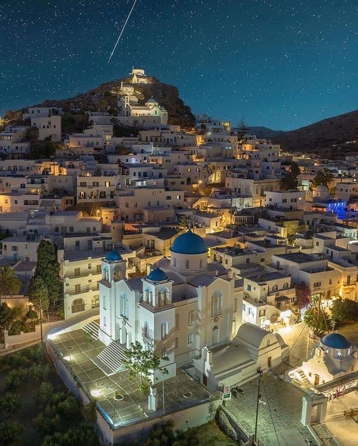 an aerial view of a city at night with the stars in the sky above it