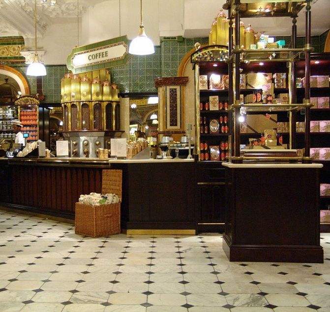 the inside of a store with lots of shelves and counter top items on display in front of them