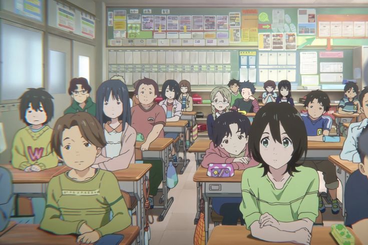 a classroom full of children sitting at desks with their backs turned to the camera