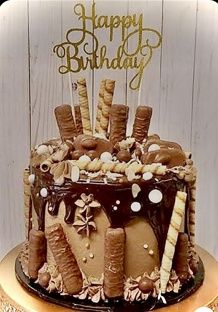 a birthday cake with chocolate frosting and marshmallows