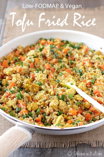 a white dish filled with rice and vegetables