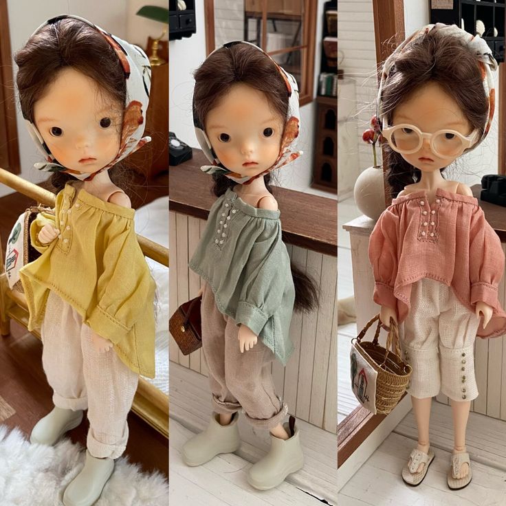 three dolls are standing in front of a mirror, one is wearing glasses and the other has a purse