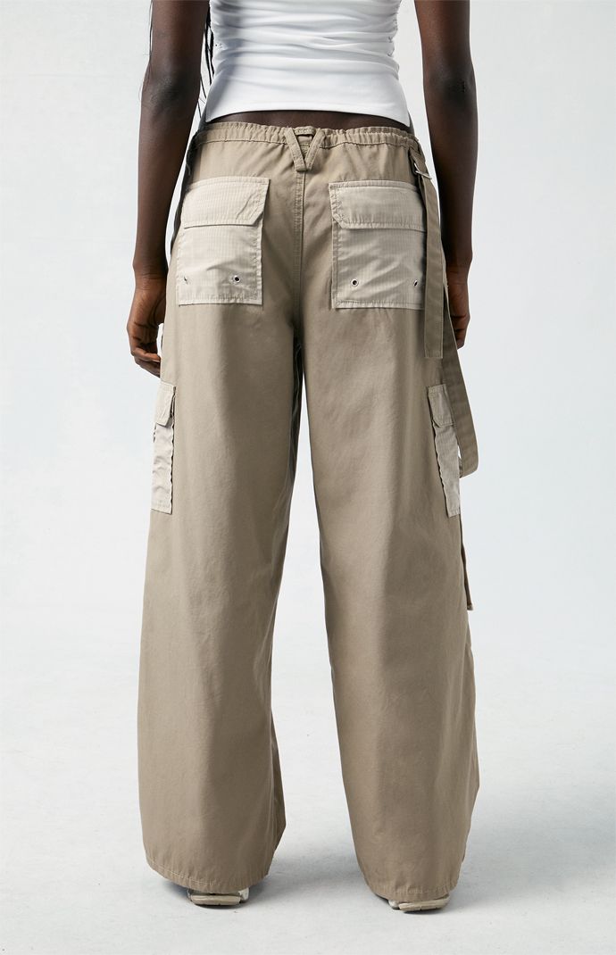 Level up your streetwear style with the PacSun Brown Toggle Baggy Cargo Pants. These on-trend mid-rise pants combine edgy style with comfort, featuring a baggy fit, cargo pockets, and an adjustable toggle waist for a customizable fit. Streetwear Straight Parachute Pants With Patch Pockets, Utility Wide Leg Pants With Pockets For Streetwear, Trendy Streetwear Parachute Pants With Patch Pockets, Straight Leg Cargo Pants For Summer Streetwear, Trendy Parachute Pants With Patch Pockets For Streetwear, Casual Wide Leg Pants With Cargo Pockets For Streetwear, Utility Style Wide Leg Pants For Streetwear, Utility Wide Leg Pants For Streetwear, Utility Wide Leg Cargo Pants For Streetwear