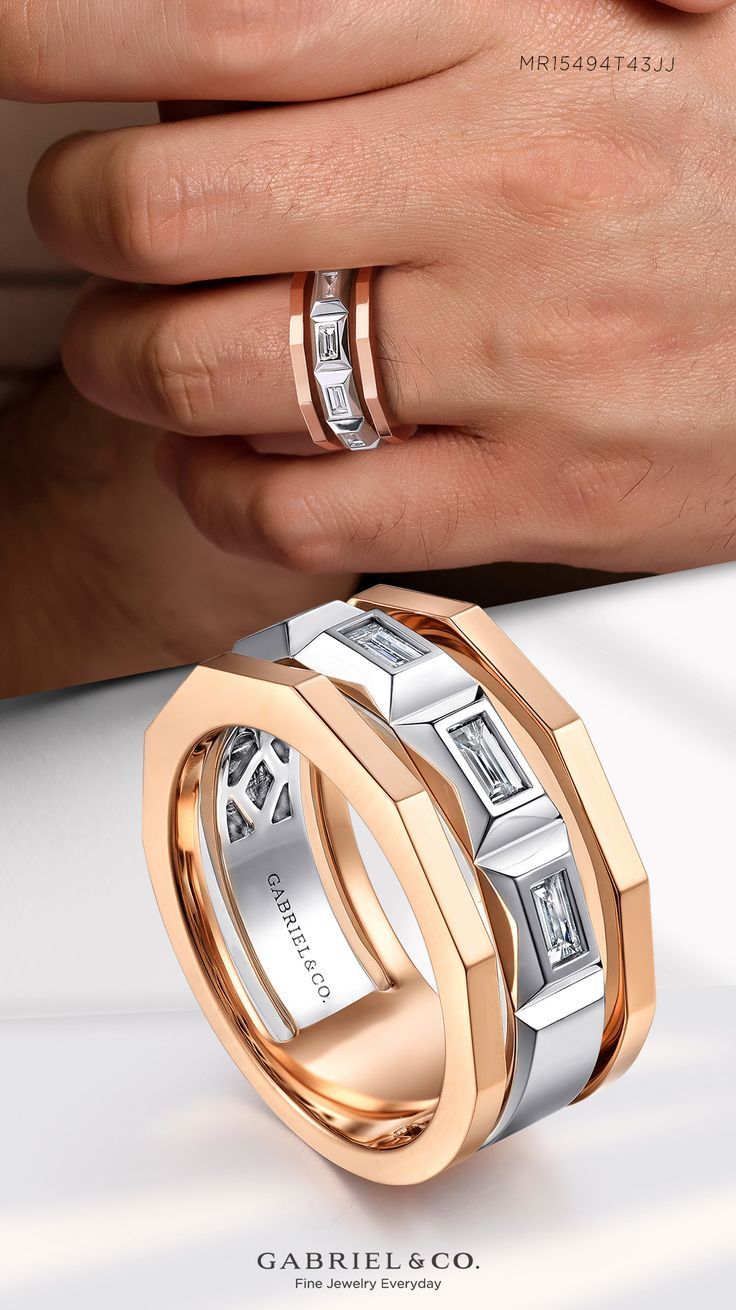 two men's hands with wedding bands and rings in gold, silver and white