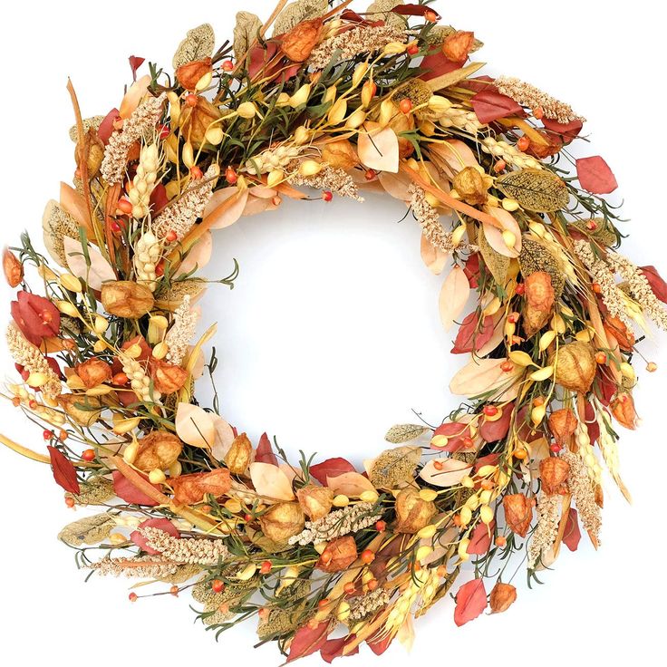 a wreath made out of dried flowers and leaves