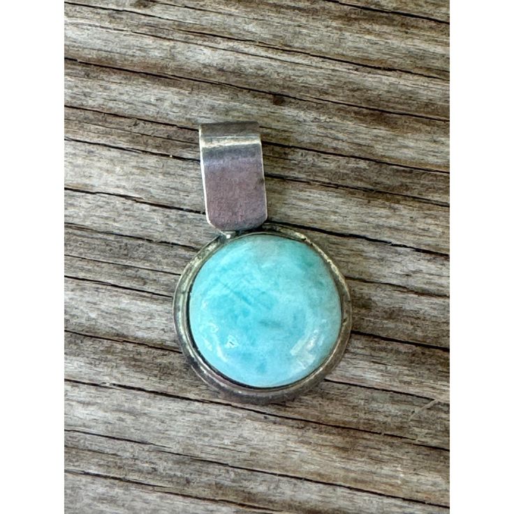 This handcrafted pendant is beautifully crafted from sterling silver, showcasing an exquisite turquoise gemstone. It will add a touch of elegance and sophistication to any outfit, making it a wonderful addition to your jewelry collection. The intricate design and natural beauty of turquoise make this pendant truly unique and eye-catching. * Handcrafted design * Sterling silver * Genuine turquoise gemstone * Unique pattern * Elegant and sophisticated * Versatile accessory * Natural stone variatio Artisan Sterling Silver Round Pendant Jewelry, Artisan Turquoise Sterling Silver Jewelry, Turquoise Spiritual Gemstones In Sterling Silver, Spiritual Turquoise Gemstones In Sterling Silver, Turquoise Pendant In Sterling Silver, Turquoise Sterling Silver Pendant Gemstone, Turquoise Pendant Gemstone In Sterling Silver, Sterling Silver Jewelry With Large Stone, Artisan Sterling Silver Gemstones With Large Stone