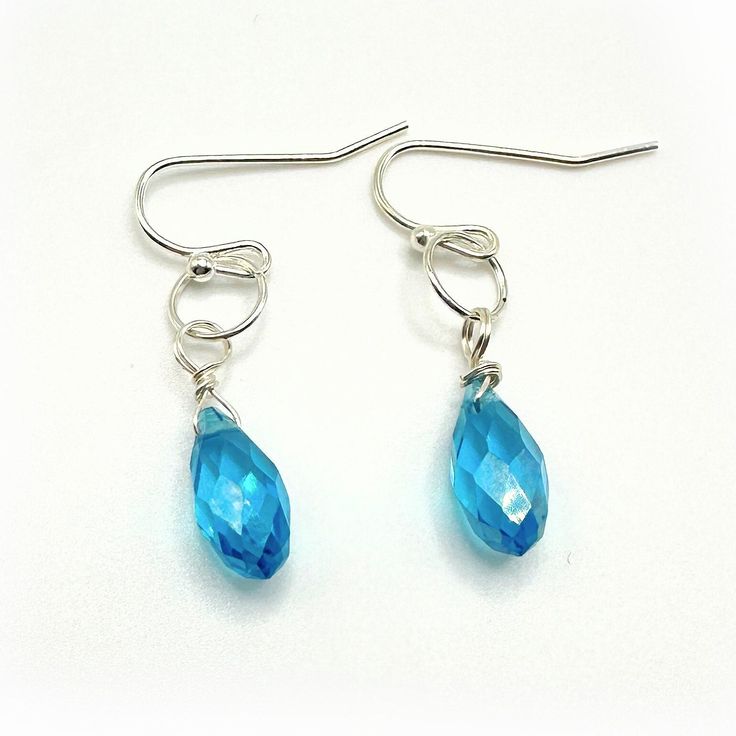 Elegant dangle earrings, a stunning combination of blue glass and silver French style ear wire. These exquisite earrings measure approximately 1 inch in length. The blue glass is 5mm in width. The wire is silver-plated. Add a touch of sophistication to any outfit with these captivating earrings. Please note that it is recommended to review all information provided before making your purchase. Care Instructions: ★Do not wear jewelry while swimming or bathing/showering. ★Keep jewelry in a dry loca Blue Wire Wrapped Drop Earrings, Blue Teardrop Wire Wrapped Crystal Earrings, Blue Nickel-free Long Drop Teardrop Earrings, Blue Silver-plated Wire Earrings, Blue Teardrop Crystal Earrings With Ear Wire, Blue Silver Plated Wire Earrings, Blue Silver-plated Drop Earrings, Light Blue Dangle Earrings In Sterling Silver, Blue Sterling Silver Crystal Earrings For Pierced Ears