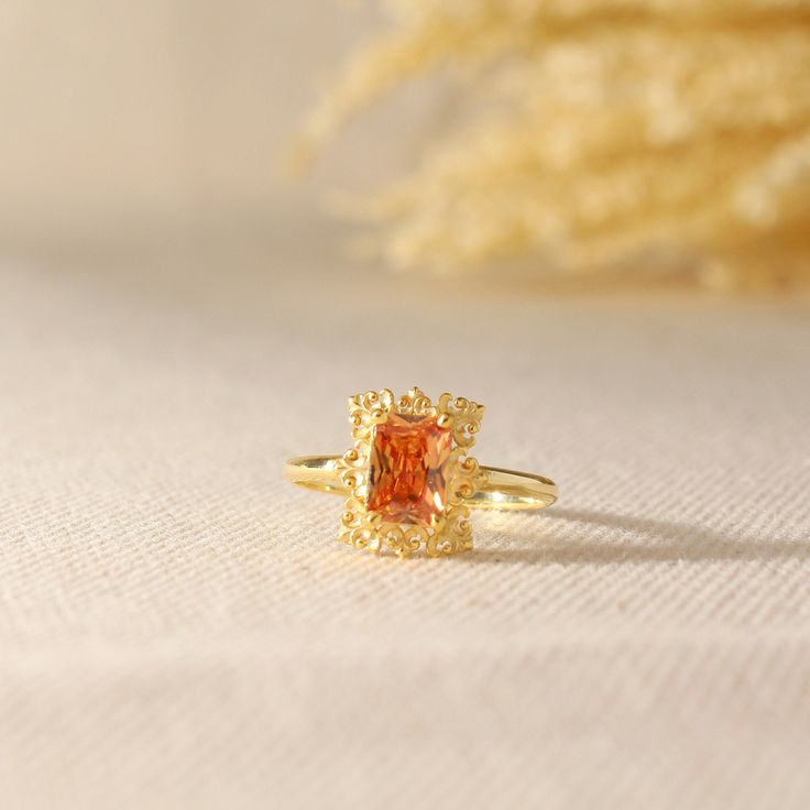 Orange Topaz Ring Gold 14k Gold Vintage Topaz Ring Gold Genuine Topaz Vintage Style Ring designed by ISEA Fine Jewelry can be a good choice as an engagement ring and a perfect birthday, anniversary gift. ➤ Ring Details * 14k / 18k Yellow Gold or Yellow Sterling Silver * Gold Color Options; 14K / 18k White, Yellow, Rose Gold * Band Width: 1.70 mm * Thickness: 1.30 mm ➤ Gem Details * Gemstone : Orange Topaz * Gem width: 5 millimeter * Gem length: 7 millimeter * Cut Type: Emerald * Ready to Ship 3- Topaz Birthstone Promise Ring In Fine Jewelry Style, Gold Open Ring With Topaz Gemstone, Topaz Birthstone Promise Ring Fine Jewelry, Fine Jewelry Topaz Birthstone Promise Ring, Rectangular Topaz Ring As Gift, Fine Jewelry Style, Rectangular Topaz Ring Fine Jewelry Gift, Fine Jewelry Topaz Ring With Rectangular Stone, Gold Topaz Promise Ring, Fine Jewelry Topaz Ring With Rectangular Stone For Gift