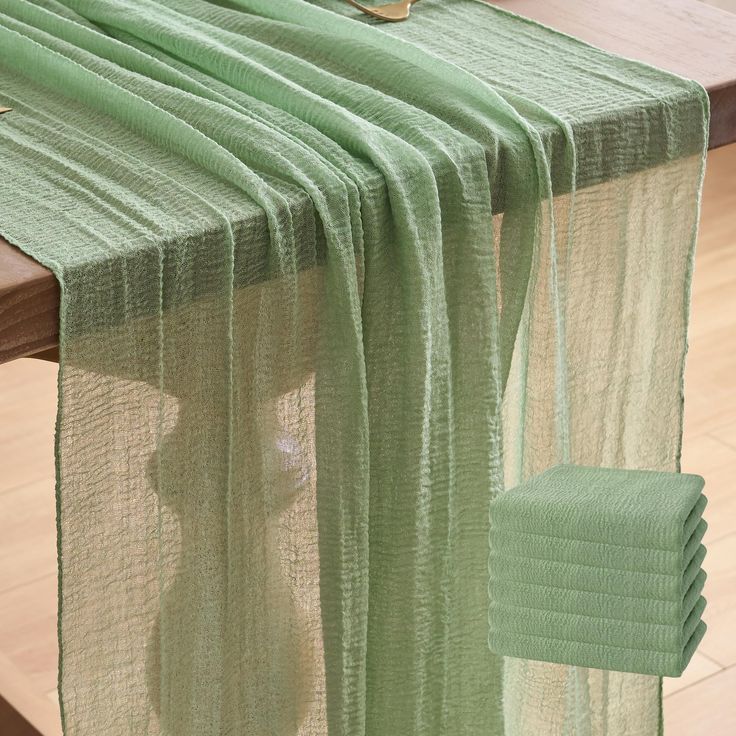 a table with a green cloth draped over it