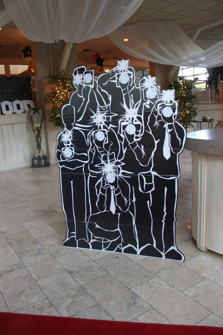 a black and white cutout of people in front of a counter at a restaurant