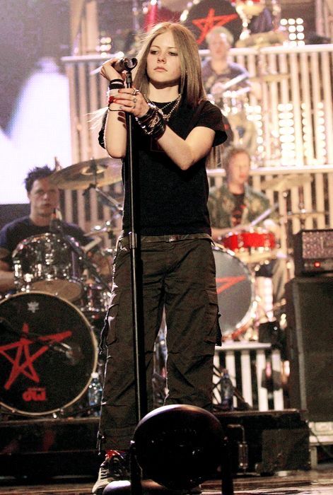 a woman standing on stage holding a microphone