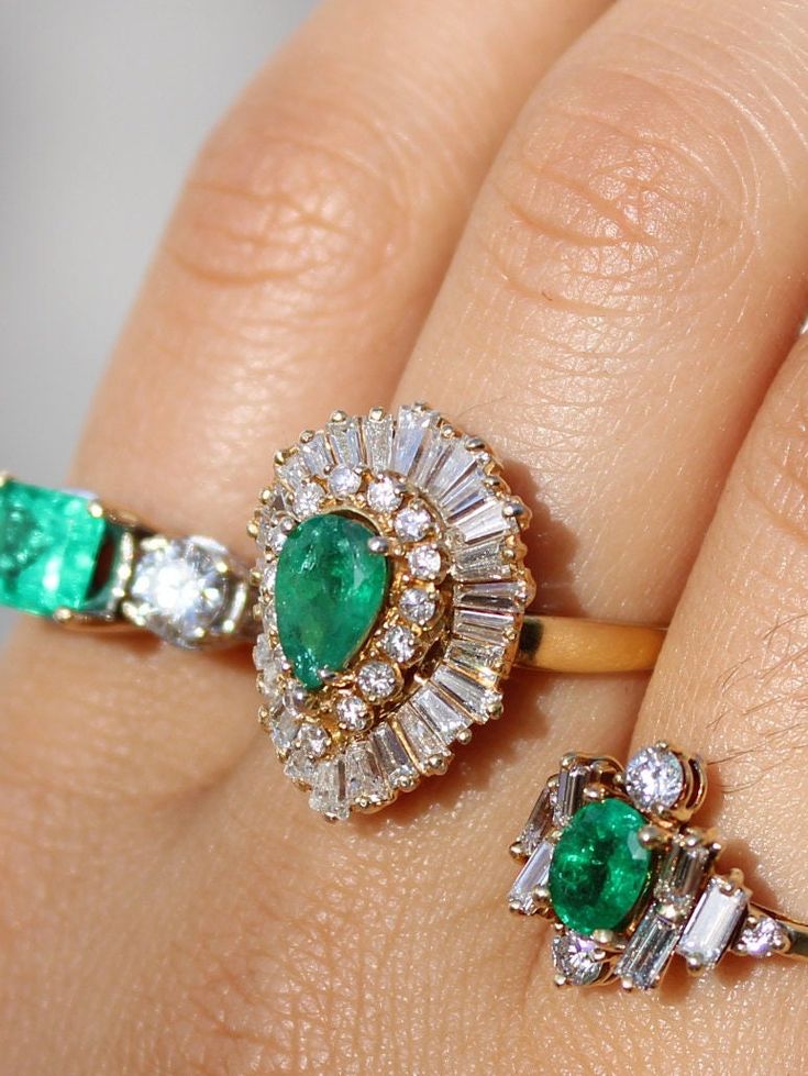 One of the most exquisite pieces found in our vault.  This Ring-Dant pre-loved vintage art deco cocktail ring is a stunning piece of art, mounted in PT950 yellow platinum, has an 2.00ct pear shaped emerald approximately and 5.00ct in baguette and round cut diamonds.  The ring size is a US 6 1/4. Ring transforms into a pendant.  We enlarge or reduce sizing if desired, after purchasing.  Please contact us if you wish to add this service. Fine Jewelry Pear-shaped Emerald Ring Vvs Clarity, Fine Jewelry Pear-shaped Emerald Ring With Vvs Clarity, Luxury Pear-shaped Diamond Ring With 17 Jewels, Luxury Pear-shaped Emerald Ring With Prong Setting, Luxury Pear-shaped Brilliant Cut Emerald Ring, Elegant Gia Certified Teardrop Diamond Ring, Elegant Gia Certified Pear-shaped Diamond Ring, Elegant Pear-shaped Emerald Ring With Prong Setting, Elegant Pear-shaped Prong Set Emerald Ring