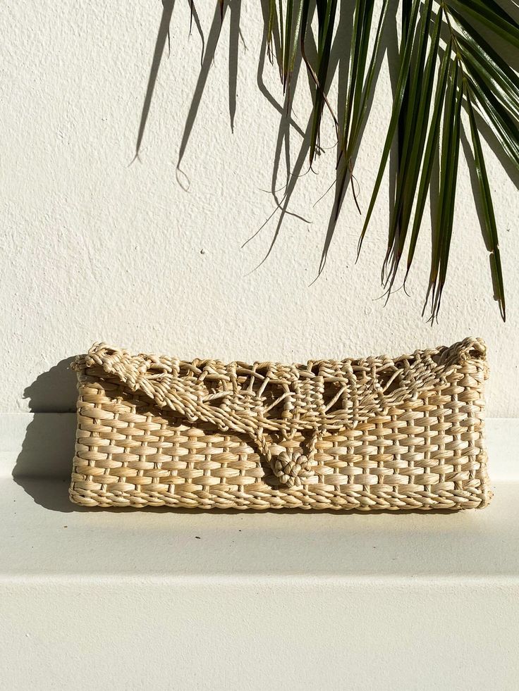 Absolutely Gorgeous clutch handmade 100% of Palm Leaves.  Lightweight and comfortable handwoven straw clutch bag. It features a beautiful natural straw color and it has a front loop for closure.  This is a great bohemian clutch bag, perfect for a beach party or wedding and a great addition for your next vacation wardrobe. It Also makes a stylish gift. Color: Natural Measurements: Length: 12"/30,5 cm Width: 1.5"/4 cm Height:5"/12,7 cm  Made in Brazil Handmade by local craftsman in the countryside Beige Rectangular Straw Clutch, Woven Rectangular Clutch For Summer, Rectangular Woven Clutch For Summer, Rectangular Natural Clutch With Braided Handles, Natural Rectangular Clutch With Braided Handles, Beige Rectangular Beach Clutch, Woven Straw Clutch, Beige Woven Straw Clutch Bag, Eco-friendly Woven Clutch For Summer