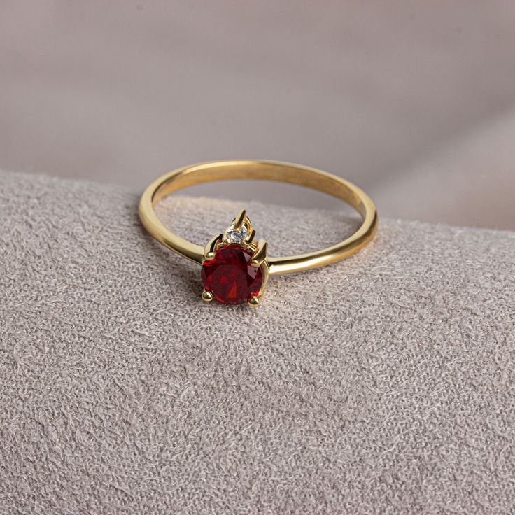 It is a stone that represents passion, true friendship, loyalty, success and consistency. It has names such as dreaming, garnet and mercy stone.. Garnet is the birthstone for those born in January. Meet the essence of elegance: Solitaire garnet ring. Handcrafted with precision, this exquisite piece features a majestic sapphire set in a magnificent design. A symbol of timeless beauty, it embodies sophistication and elegance. Elevate your style with this breathtaking masterpiece. A stylish jewel f Formal Ruby Ring With Cubic Zirconia In Round Band, Formal Cubic Zirconia Ruby Ring With Round Band, Formal Cubic Zirconia Ruby Ring, Elegant Gold Diamond Ring For Proposal, Elegant Yellow Gold Diamond Ring For Proposal, Fine Jewelry Cubic Zirconia Diamond Ring For Proposal, Classic Crystal Ring With Cubic Zirconia, Elegant Birthstone Ring With Gemstone, Elegant Birthstone Ring With Round Gemstone