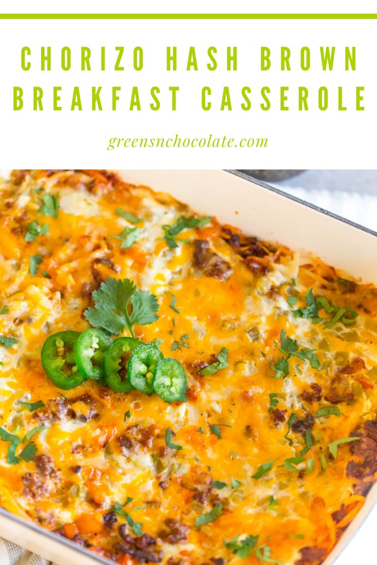 an enchilada casserole in a white dish with green peppers and cilantro