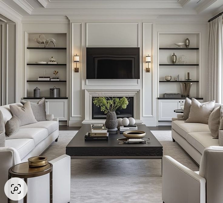 a living room filled with furniture and a flat screen tv mounted on the wall above a fireplace