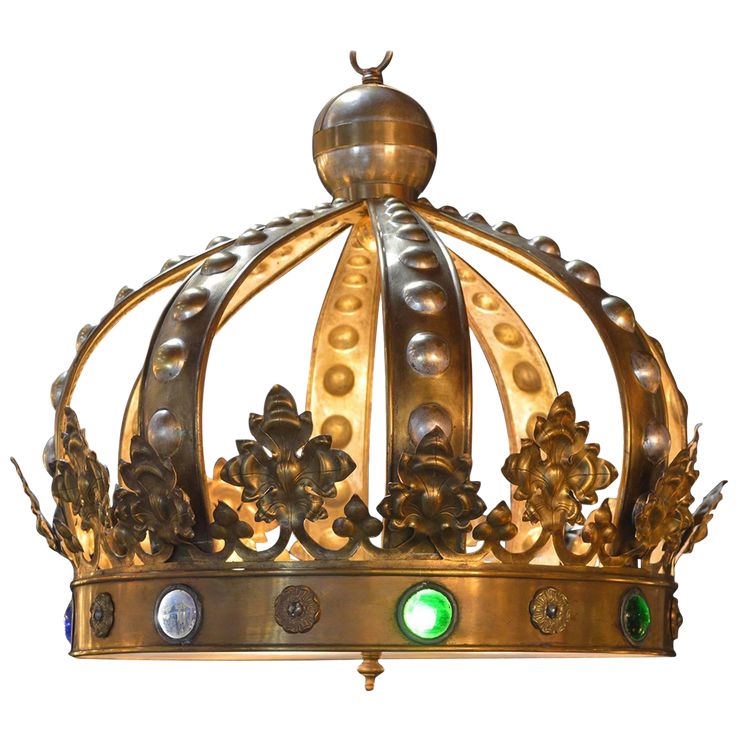 a gold crown with green jewels on the front and sides is seen against a white background