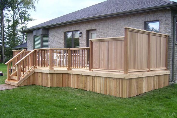 a wooden deck in front of a house