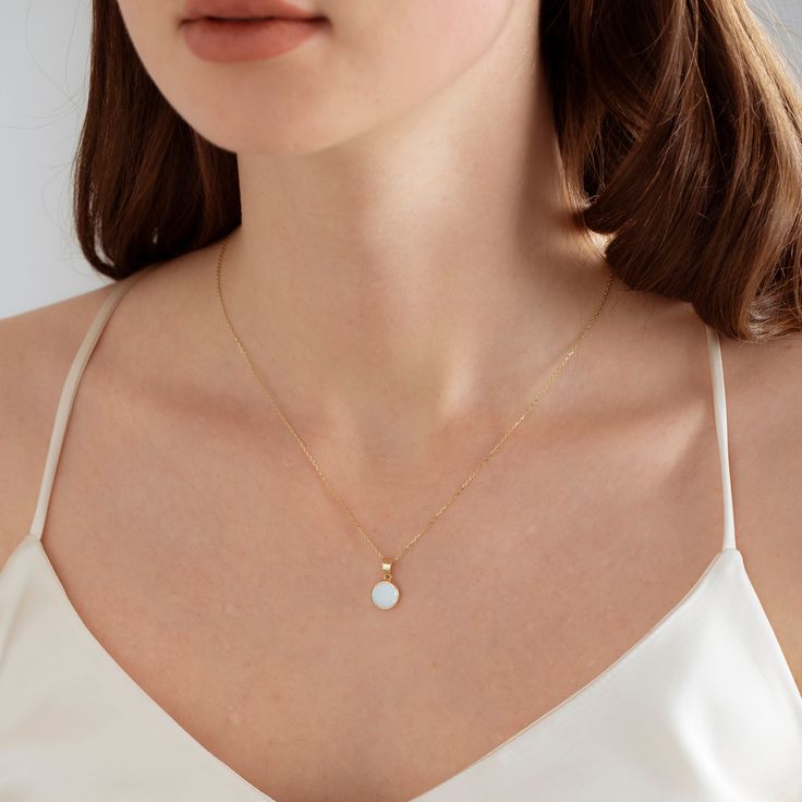 "Oval White Opal Solitaire Necklace, 10K and 14K Solid Gold Bridal Necklace, Bridesmaid Necklace, OpalNecklace, Cute Necklace, Girlfriend Necklace, Delicate Necklace  ⚪MATERIAL We manufacture our products from 10K and 14K solid gold. ⚪This is a very elegant and beautiful White Opal necklace with a lab-created oval-shaped opal, great iridescence, and sheen, with one diamond simulant on top. ⚪In the Middle Ages, Opal was considered a stone that could provide great luck because it was believed to possess all the virtues of each gemstone whose color was represented in the color spectrum of the opal. ⚪Classic Oval shape cute necklace with chain, which perfectly matched any occasion. Wearing this special Opal necklace could be a protection amulet to ward off misfortune. Necklaces can bring good Formal White 14k Gold Necklace, Formal White Charm Necklace With Clavicle Chain, Minimalist White Birthstone Necklace, Minimalist White Gemstone Birthstone Necklace, Dainty White Round Birthstone Necklace, Minimalist White 14k Gold Jewelry, Delicate White Round Jewelry, Formal White Birthstone Necklace, White Necklace With Delicate Chain