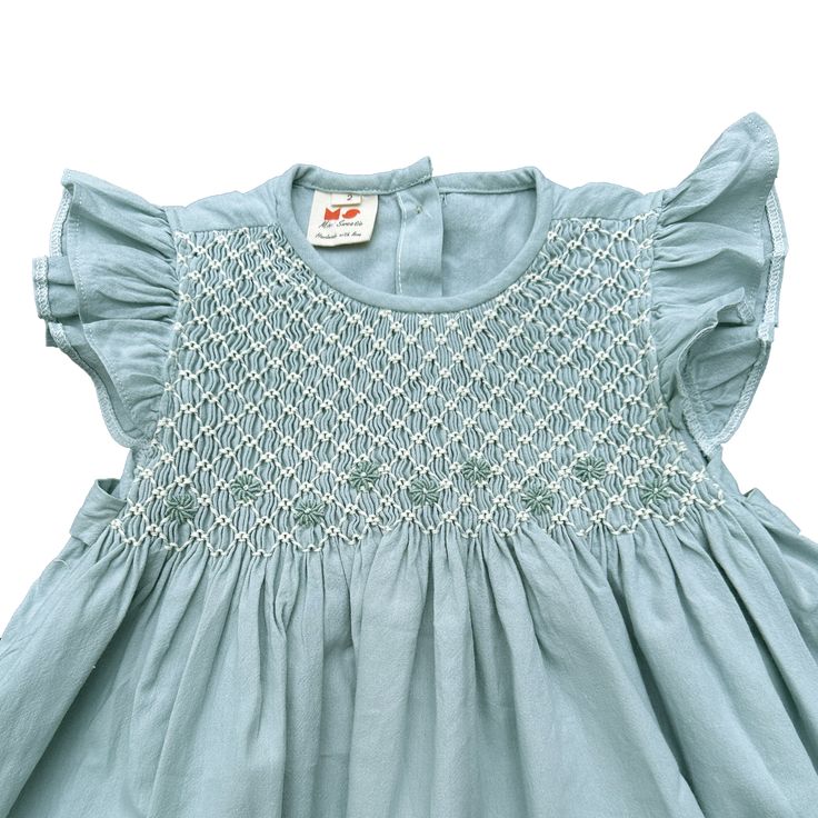 The Pastel Mint Smocked Dress embodies the essence of springtime freshness and effortless charm. It has deliciated hand smock from shoulder to chess, suitable for both formal and casual occasions.  * 100% Cotton * 100% Handmade * Tie at the back * Soft cotton, comfortable, and ready to play * Hand wash or machine wash on a delicate setting We are based in Sydney, New South Wales, Australia. We ship within Australia and to other countries as well. The shipping fee is vary based on the destination Flutter Sleeve Smocked Dress With Ruffles For Garden Party, Ruffle Sleeve Dress With Smocked Back For Garden Party, Spring Smocked Dress With Flutter Sleeves, Spring Smocked Dress With Flutter Sleeves And Smocked Bodice, Summer Cotton Smocked Dress With Flutter Sleeves, Cotton Smocked Dress With Flutter Sleeves And Ruffles, Spring Dress With Smocked Back And Ruffle Sleeves, Spring Dresses With Smocked Bodice And Ruffle Sleeves, Casual Smocked Flutter Sleeve Dress For Garden Party