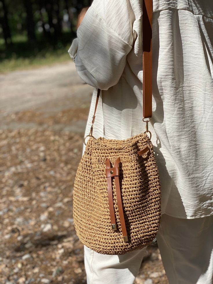 Any woman must have this bag for every fashionista. Whether you keeping it to yourself or gifting someone you care, it will be unforgettable. ✅I made this beautiful bucket bag from natural paper rope which is organic cotton and vegan leather in TAN. ✅This bag is light weight yet durable, breathable and environmental at the same time. ✅Bucket bag has a cotton lining and adjustable strap. If you want, you can shorten the strap length and use it as a shoulder bag. Height: 26 cm Depth: 20 cm ✅The in Trendy Natural Bucket Bag With Removable Pouch, Leather Crochet Bag For Everyday, Chic Travel Straw Pouch Bag, Natural Pouch Bag With Adjustable Strap, Trendy Natural Color Hobo Bag In Pouch Shape, Natural Bucket Bag For Everyday Use, Trendy Natural Color Hobo Bag Pouch, Natural Color Bucket Bag For Everyday Use, Eco-friendly Crochet Bucket Bag With Adjustable Strap