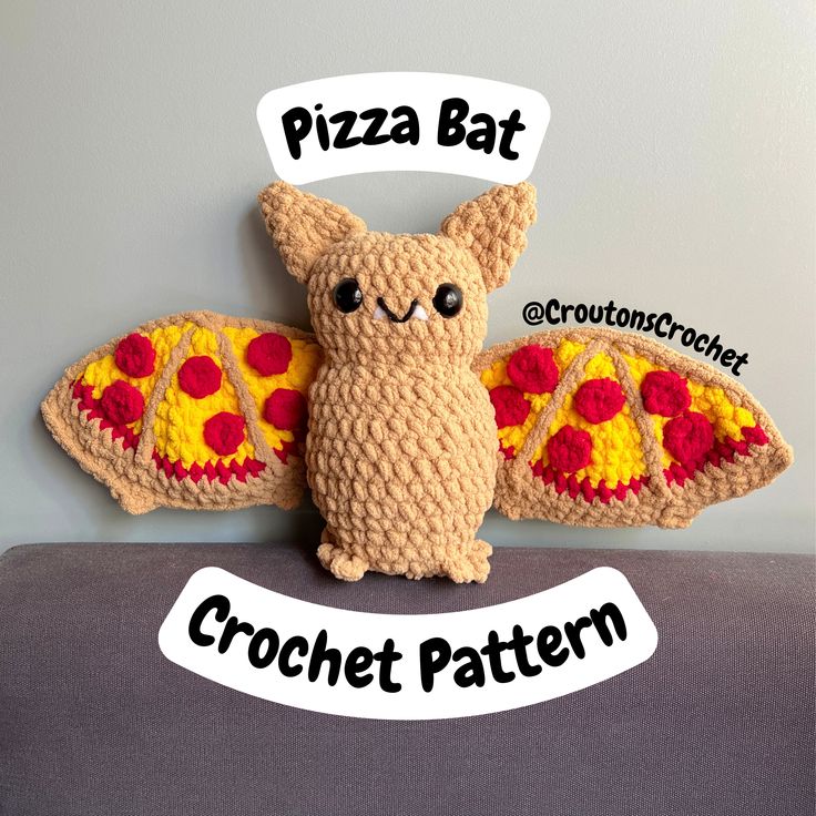 a crocheted stuffed animal with the words pizza bat on it's back