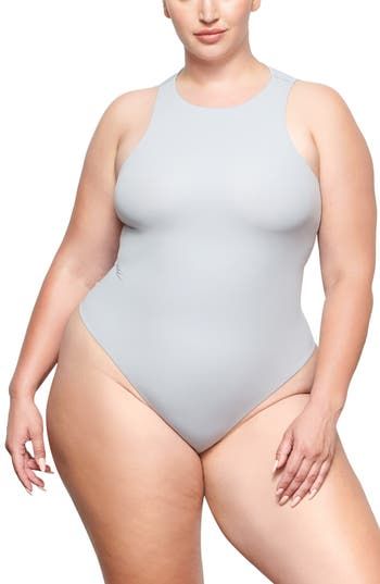 Sculpt your body's natural shape with a high-neck bodysuit from Kim Kardashian West's SKIMS that holds you in and lifts you up in all the right places. Reflecting the brand's passion for highly technical shapewear solutions for every body, this everyday piece has whisper-soft, seamless construction, high-cut legs and a thong back that remains invisible under clothing. Snaps between legs Crewneck Sleeveless Lined 76% polyamide, 24% elastane Machine wash, tumble dry Imported Women's Clothing Sleek Compressive Smoothing Bodysuit, High Neck Nylon Bodysuit, Stretch High Neck Elastane Swimwear, Stretch High-neck Elastane Swimwear, High-neck Stretch Swimwear, High Neck Stretch Elastane Swimwear, High Neck Bodysuit With Minimal Stretch, Solid High Neck Bodysuit With Minimal Stretch, Sleek High Stretch Solid Shapewear