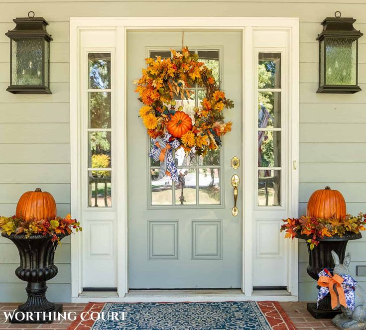 two pumpkins are sitting on the front porch