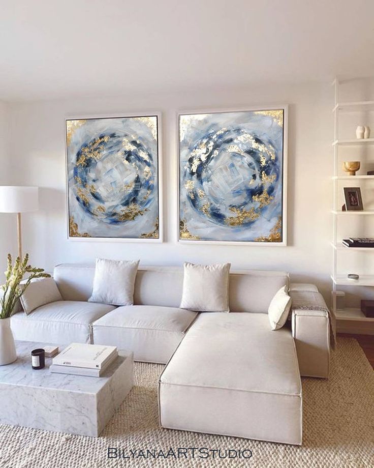 a living room with two paintings on the wall