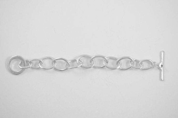 My friend Alana has been in my book group for 27 years. Her silver link bracelet that I have always admired is the inspiration for this bracelet. Three individual link styles and a custom toggle come together to create this stunning bracelet. Wear it alone or stack it with other bracelets for an arm party! Sterling silver 8" long Modern Link Bracelet With Rolo Chain, Modern Bracelets With Rolo Chain And Oval Link, Everyday Silver Charm Bracelet With Oval Links, Silver Bracelets With Adjustable Oval Link Chain, Silver Bracelet With Adjustable Chain And Oval Links, Modern Oval Link Bracelet With Extender, Modern Silver Charm Bracelet With Extender, Sterling Silver Charm Bracelet With Adjustable Chain, Adjustable Silver Chain Bracelet With Oval Links