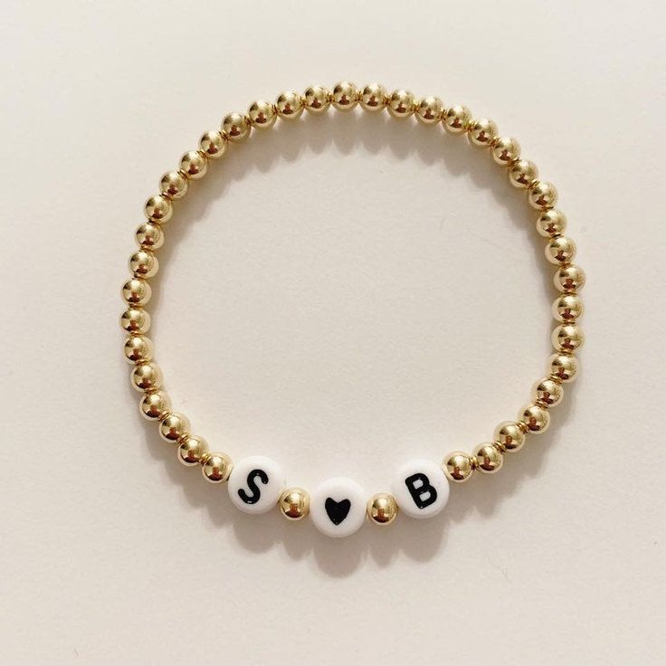 This listing is for one beaded bracelet (sterling silver, 14k gold or 14k rose gold) with your choice of letters for initials and a black heart bead. Please letters you want and your wrist size in the notes at check out. Kids size is 5 inches Bracelets are stretchy. Sizing- Please make sure to measure your wrist correctly before placing an order. To measure, measure snug and add 1/2 inch to that number. For example if your wrist measures 6 inches you want to purchase a size 6 1/2. Buyer is respo Personalized Gold Jewelry With Round Beads, Gold Jewelry With Round Beads For Personalized Gift, Elegant Beaded Bracelets With Letter Beads As Gift, Elegant Beaded Bracelets With Letter Beads For Gift, Dainty Beaded Name Bracelet For Everyday, Elegant Gold Beaded Bracelet With Custom Name, Classic Letter Beads Jewelry As Gift, Elegant Hypoallergenic Name Bracelet With Round Beads, Classic Letter Beads Jewelry Gift