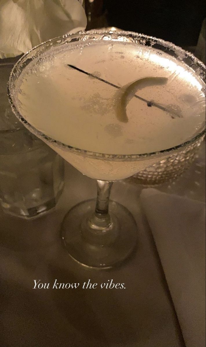 a glass filled with liquid sitting on top of a table