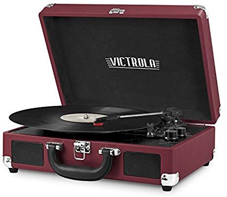 a suitcase with a record player in it and the word victrola on top