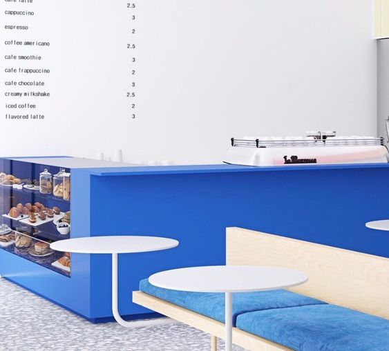 a blue counter and some white tables in a room