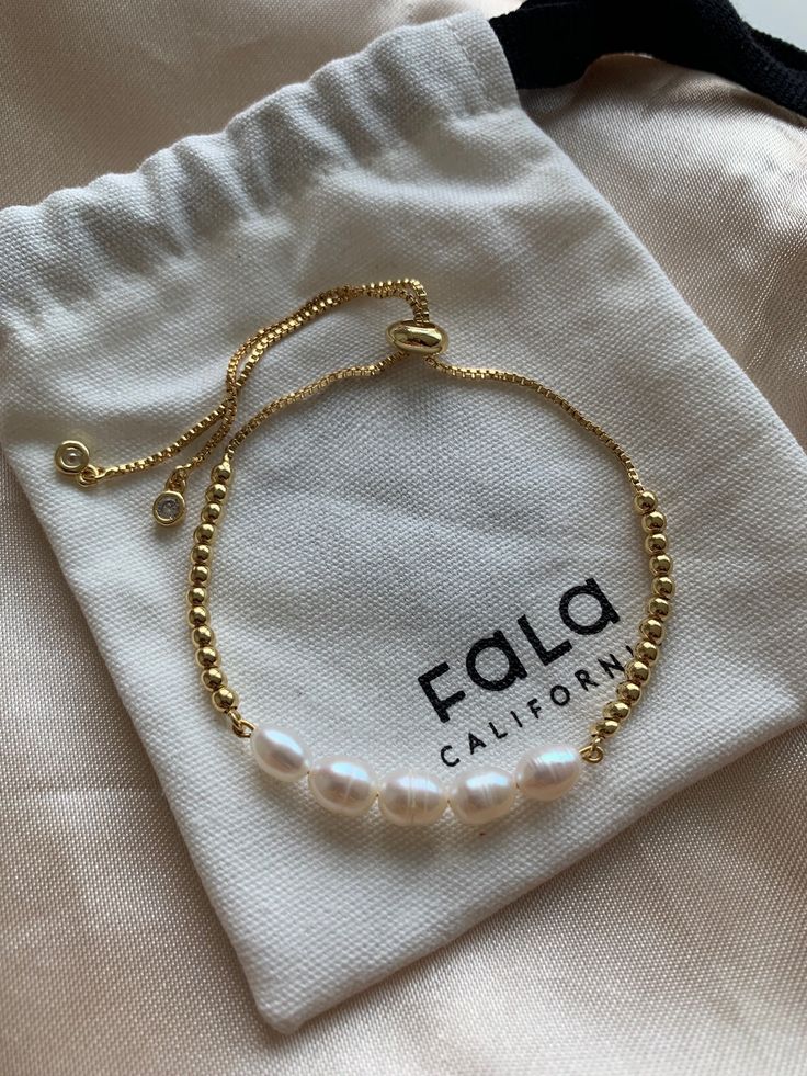 Perfect to layer or wear alone, Whether you like your bracelets loose or close to the wrist, our freshwater pearl gold Adjustable Chain Bracelet in White Pearl is a delicate addition to any arm party. This stunning chain bracelet is a perfect go-to for everyday wear and adds a little extra sparkle to your outfit. Wear it alone or stack on more for a trend-forward look. Classic jewelry vibe combined with the fashion-forward trend. Sightly adjustable, comfortable for daily wear, suitable for every Cheap Minimalist White Pearl Bracelet, Elegant Cheap Pearl Bracelet For Gift, Gold Bracelet With Pearls, Adjustable Gold Bracelets With Pearl Drop, Adjustable Gold Pearl Drop Bracelet, Delicate Adjustable Pearl Bracelet, Dainty Gold Bracelets With Pearl Chain, Dainty Adjustable Pearl Bracelet, Dainty Gold Pearl Bracelet With Pearl Charm