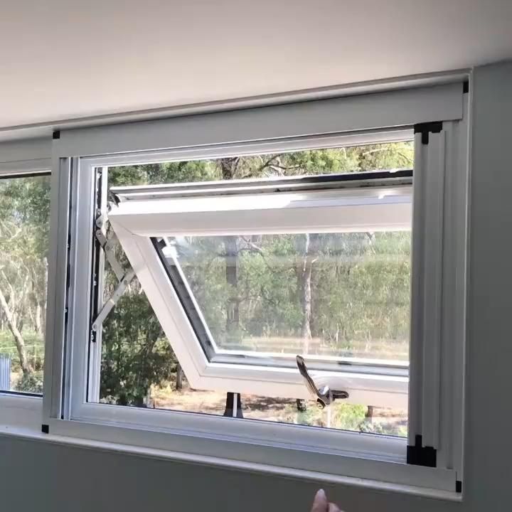 an open window in a house with trees outside