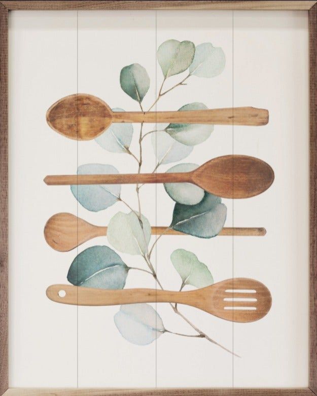 wooden spoons and spatulas are arranged in a wood frame on a white wall