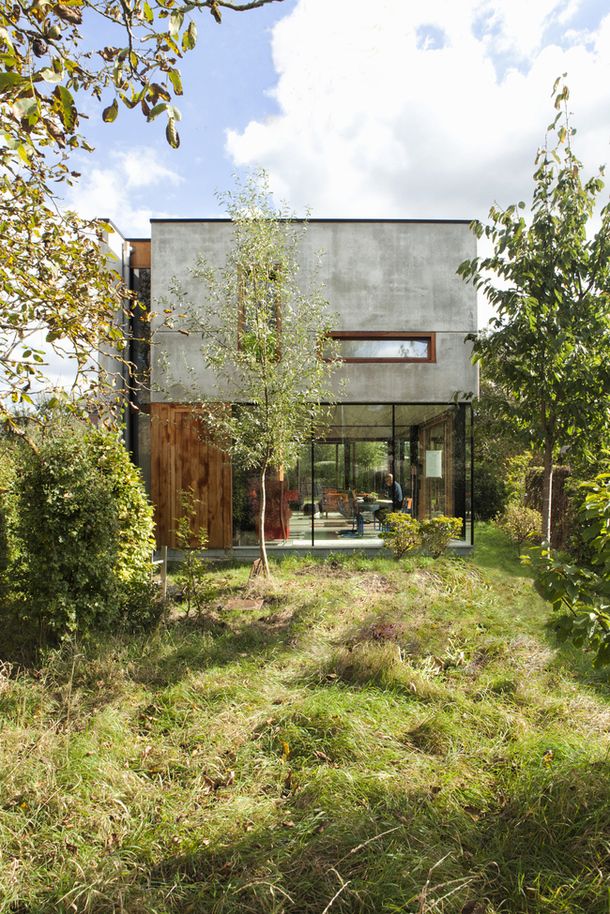 the house is surrounded by trees and grass