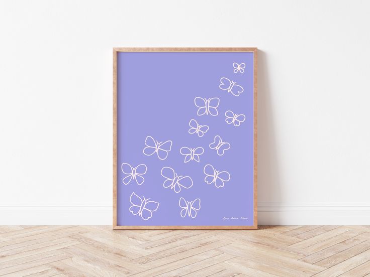 a purple poster with white butterflies on it in front of a wooden floor and wall