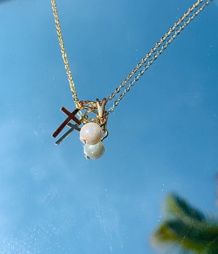 "18 Karat Gold Filled Cross Pearl Charm on a .925 Gold Necklace The perfect religious gift or dainty everyday wear cross necklace.  Material: 18 Karat Gold Filled + Sterling Silver Gold Plated Chain Length: Options Available. The 11.75\" Chain  comes with a 2\" extension and is generally recommended for kids. Proper Care for your new MaLiBeads: Gold Filled and .925 products are very durable; however, please remember to apply beauty products such as perfume, hairspray or deodorant before wearing Gift Pearl Necklace With Cross Pendant, Pearl Cross Pendant Necklace Gift, Pearl Necklace With Cross Pendant For Gifts, Pearl Drop Cross Pendant Necklace For Gift, White Spiritual Necklace For Mother's Day, Spiritual White Necklace For Mother's Day, Gift Pearl Charm Cross Pendant Necklace, Pearl Charm Cross Necklace For Gift, Pearl Cross Pendant Jewelry Gift