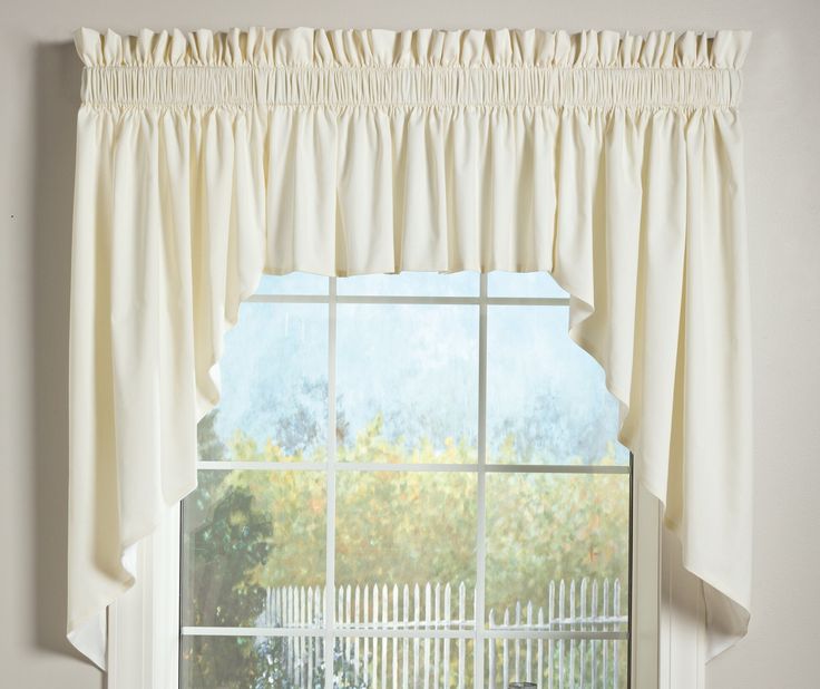 an open window with a white curtain hanging from it's side