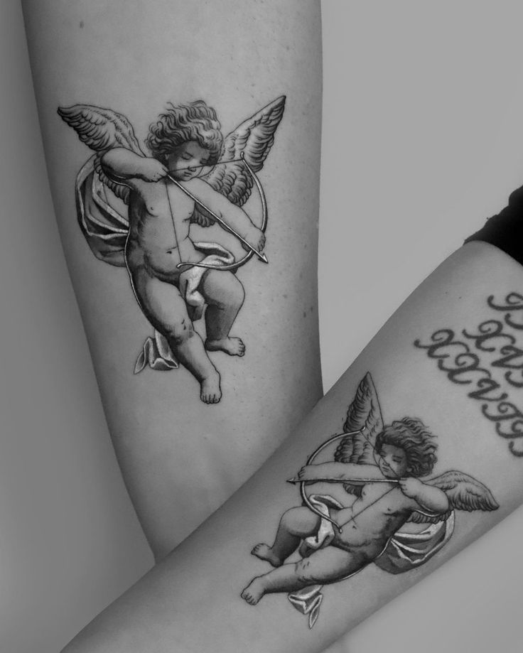 two people with tattoos on their legs, one has an angel and the other has a cupid