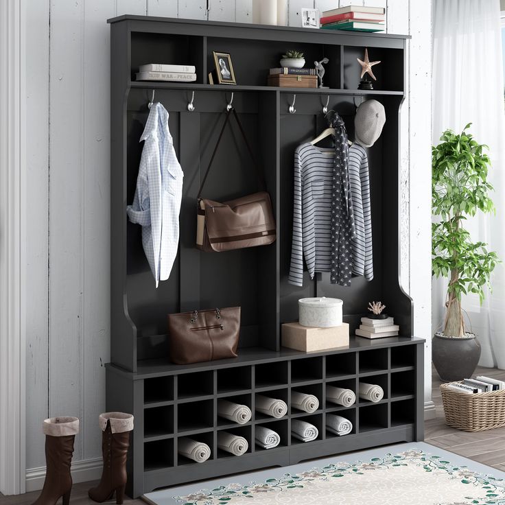 a room with a coat rack, purses and shoes on it's shelves