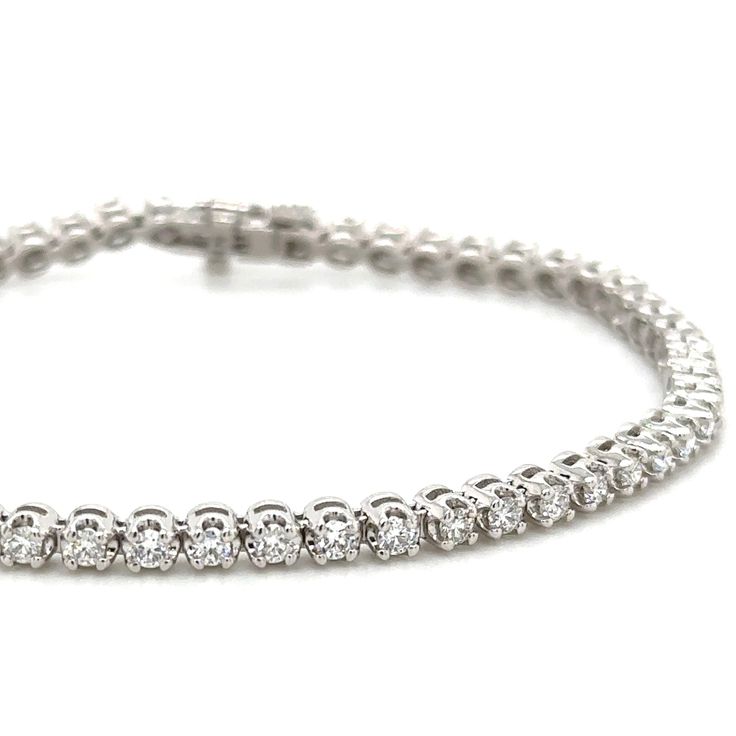 This beautiful Diamond Riviera Line Tennis Bracelet offers sparkling sophistication for any occasion with 1.95ct t.w. of dazzling diamonds, it will make you shine with undeniable elegance. Make your statement of style today! Metal: 14K White GoldDiamond Weight: Rounds Brilliant cuts 1.95ct t.w.Bracelet Length: 18cmLock: Box Catch With Hidden Safety Estimated production time is 4 - 5 weeks. Dazzling Platinum Tennis Bracelet With Prong Setting, Diamond White Brilliant Cut Tennis Bracelet, Brilliant Cut Moissanite Tennis Bracelet, Lab Grown Diamond Bracelet With Prong Setting, Timeless Diamond White Tennis Bracelet With Diamond Accents, Dazzling Diamond Tennis Bracelet With Pave Setting, Diamond Tennis Bracelet With Brilliant Round Cut, Timeless Tennis Bracelet With Pave Setting In Cubic Zirconia, Diamond Tennis Bracelet With Brilliant Cut